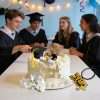 Complete graduation cake topper set styled on cake for group graduation party dessert table decor