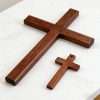 Wooden Cross Wall Decor Set two size large and small solid wood crosses laid flat on marble tabletop