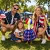 Family posing with patriotic lawn goose costume for outdoor 4th of July party holiday decorations