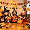 Kids Halloween home party with indoor decorations banner hanging swirls and festive backdrop