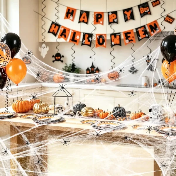 Halloween indoor decorations on kitchen party table with spider web balloons and Happy Halloween banner