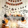Halloween indoor decorations set on fireplace with mantel scarf banner 3D bats balloons and spider web