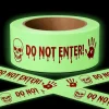 Allyix glow in the dark Halloween caution tape roll with skull, bloody handprints and Do Not Enter print, crossed strips glowing green