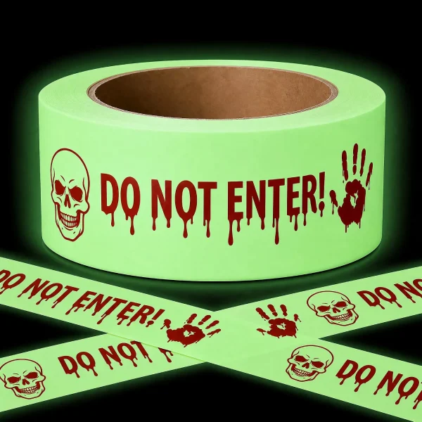 Allyix glow in the dark Halloween caution tape roll with skull, bloody handprints and Do Not Enter print, crossed strips glowing green