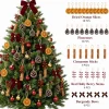 Close-up of the decorated tree with counts – dried orange slices 18, pinecones 10, cinnamon sticks 8 pairs, red holly berry stems 6, burgundy bows 6