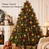 Vintage natural Christmas tree ornaments – a full tree by a fireplace dressed with orange slices, cinnamon, pinecones, red berries and velvet bows