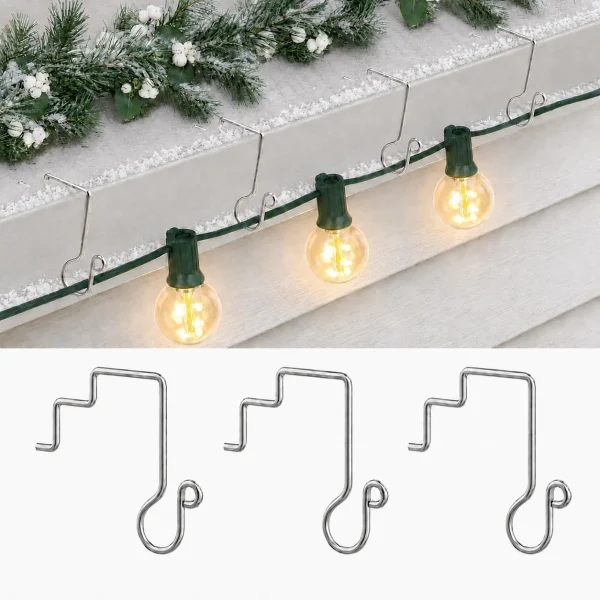 Allyix stainless steel gutter clips holding a G40 Christmas light string on a snow-covered gutter, with three clips shown on white