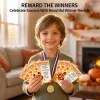 Boy wearing a gold winner medal and holding Thanksgiving turkey hunt game cards