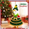 Porch goose in the Christmas tree outfit standing in snow in front of a lit house entrance with wreaths