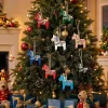 Christmas tree in a living room decorated with red baubles and the eight colorful Dala horse ornaments