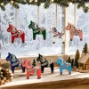 Dala horse ornaments hanging in front of a frosted winter window