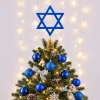 Allyix blue wooden Star of David tree topper on a gold spring base at the top of a lit tree with blue ball ornaments