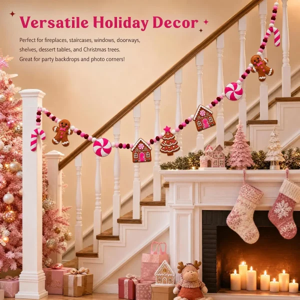 Versatile holiday decor – the pink gingerbread garland running along a staircase banister above a fireplace with pink stockings and gifts