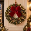 Close-up of the 7.8 inch red velvet bow on linen showing the red elastic hanging cord