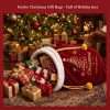 The burgundy velvet Santa sack lying under a lit Christmas tree with wrapped gifts spilling out